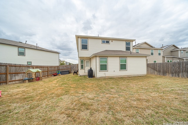 rear view of house with a yard