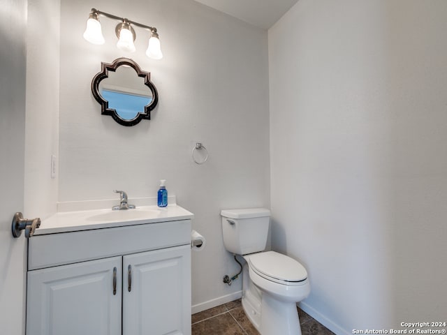 bathroom featuring vanity, toilet, and tile patterned floors