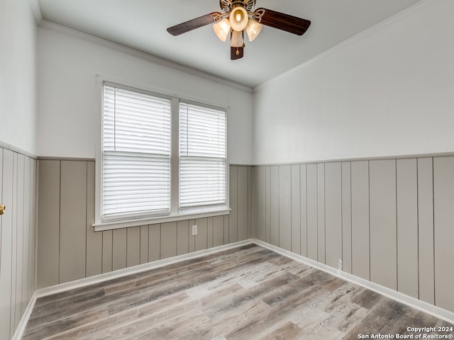 unfurnished room with crown molding, wood-type flooring, and ceiling fan