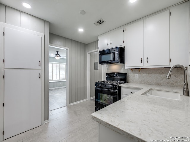 kitchen with tasteful backsplash, black appliances, sink, ceiling fan, and white cabinets