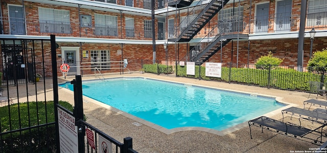 view of swimming pool featuring a patio area