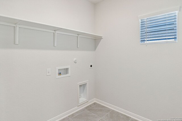 laundry room with hookup for a gas dryer, hookup for a washing machine, light tile patterned floors, and hookup for an electric dryer