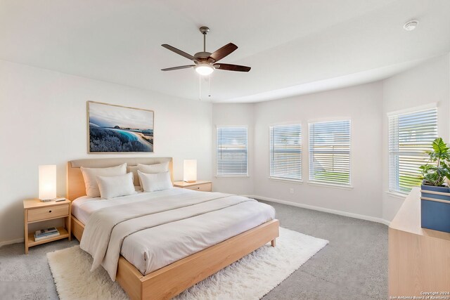 bedroom featuring light colored carpet and ceiling fan