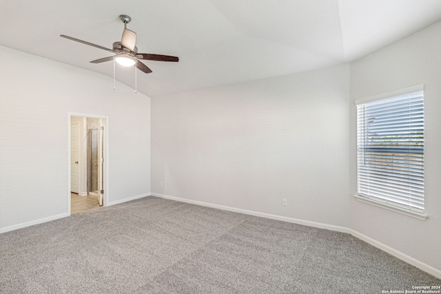 carpeted empty room with ceiling fan and lofted ceiling