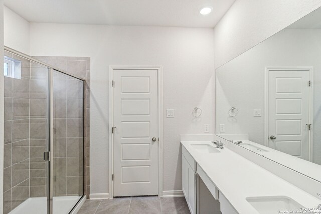 bathroom with tile patterned floors, vanity, and a shower with shower door