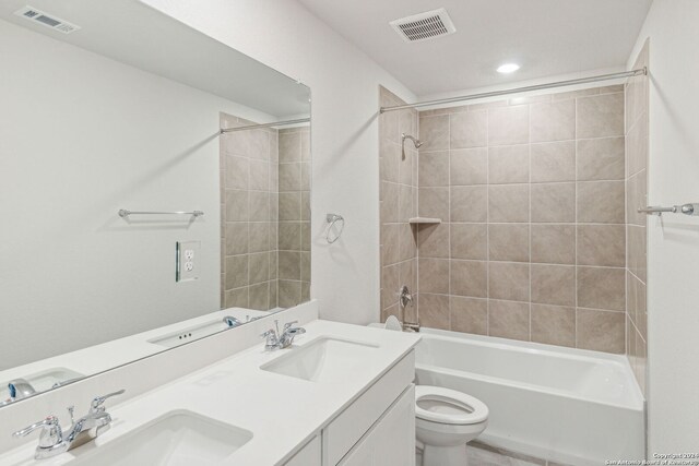 full bathroom with vanity, toilet, and tiled shower / bath