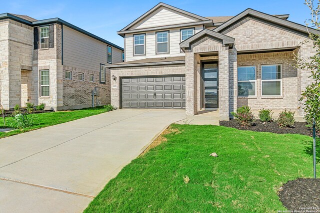 view of front of house with a garage and a front yard