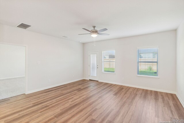 unfurnished room featuring light hardwood / wood-style flooring and ceiling fan