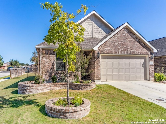 view of front of property featuring concrete driveway, brick siding, a front yard, and a garage