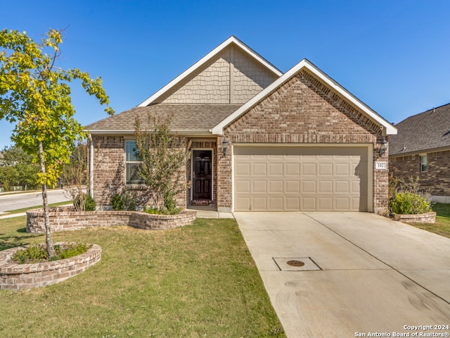 view of front of house with a front lawn and a garage