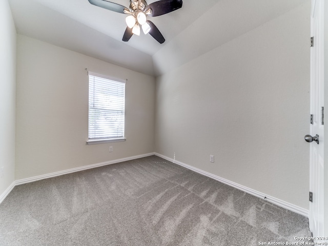 carpeted empty room featuring ceiling fan and lofted ceiling