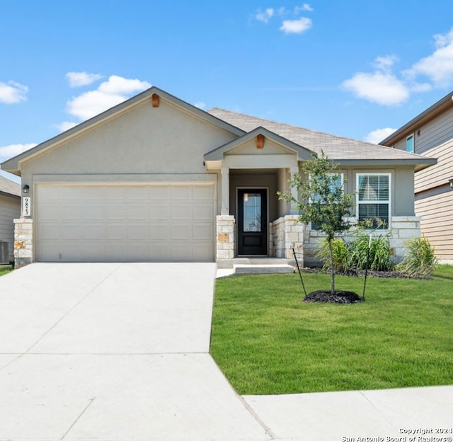 view of front of property with central air condition unit, a front lawn, and a garage