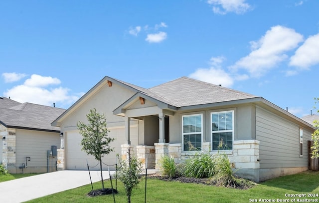 view of front of house featuring a front yard and a garage