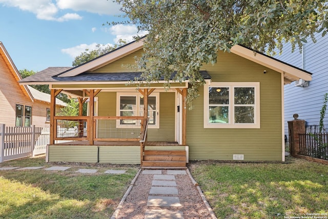 bungalow featuring a porch and a front lawn