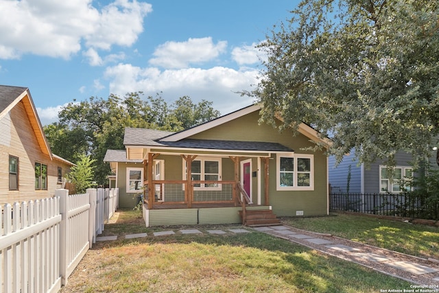 bungalow-style home featuring a porch and a front lawn