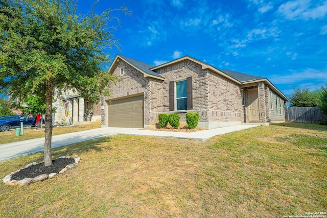 view of front of home featuring a front yard and a garage