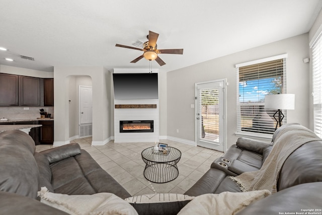 tiled living room featuring ceiling fan