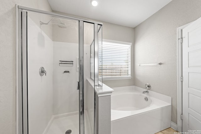 bathroom featuring independent shower and bath and tile patterned flooring