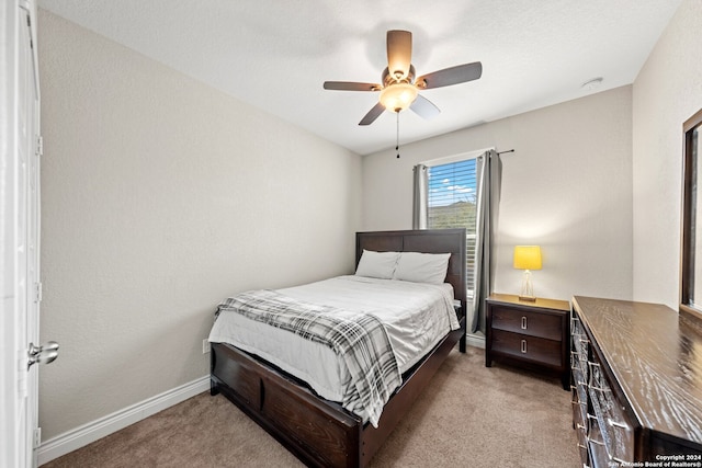 bedroom with light colored carpet and ceiling fan