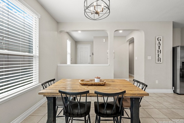 dining room featuring an inviting chandelier and light tile patterned floors