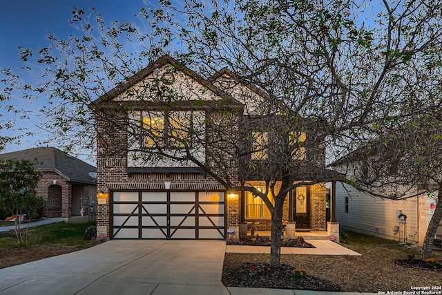 view of front of property with a porch and a garage