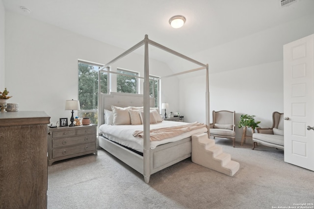 carpeted bedroom featuring vaulted ceiling