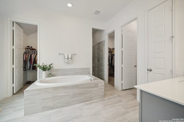 bathroom featuring vanity and shower with separate bathtub