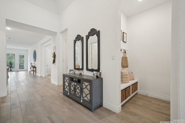 corridor with hardwood / wood-style flooring