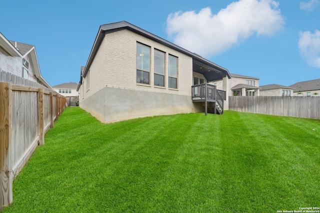 back of property featuring a lawn