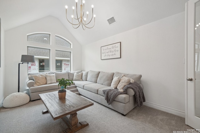 carpeted living room with a chandelier and high vaulted ceiling