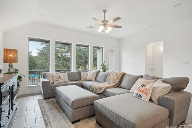 living room featuring ceiling fan and vaulted ceiling