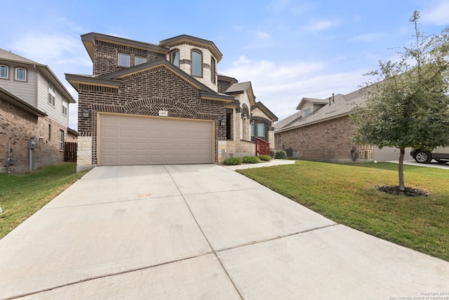 view of front of home featuring a front yard and a garage