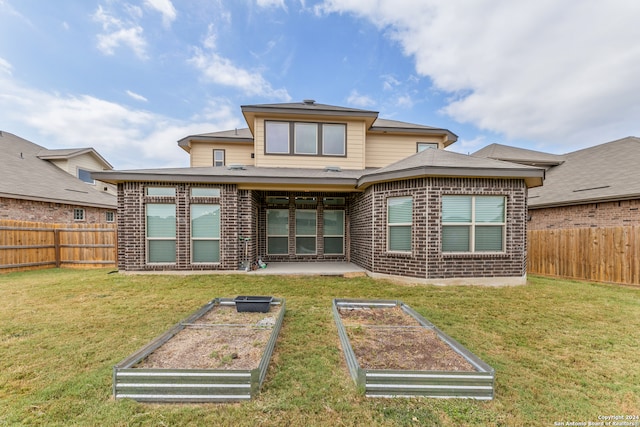 rear view of property featuring a yard