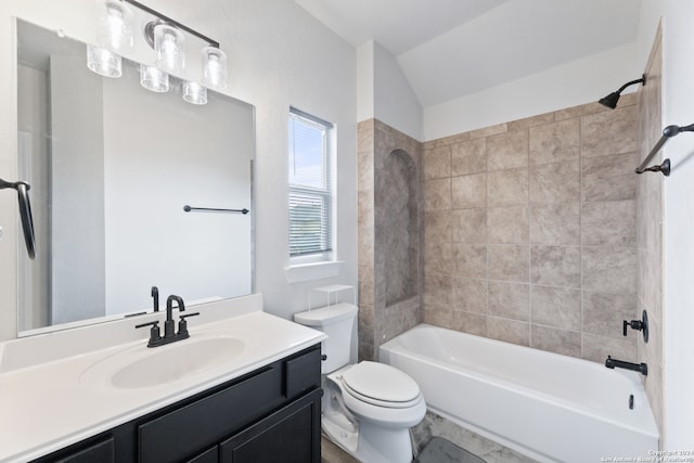 full bathroom with vanity, toilet, tiled shower / bath combo, and lofted ceiling