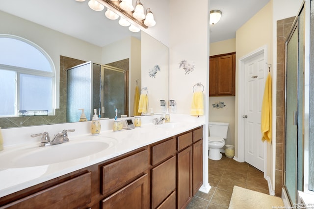 bathroom with a healthy amount of sunlight, vanity, toilet, and walk in shower