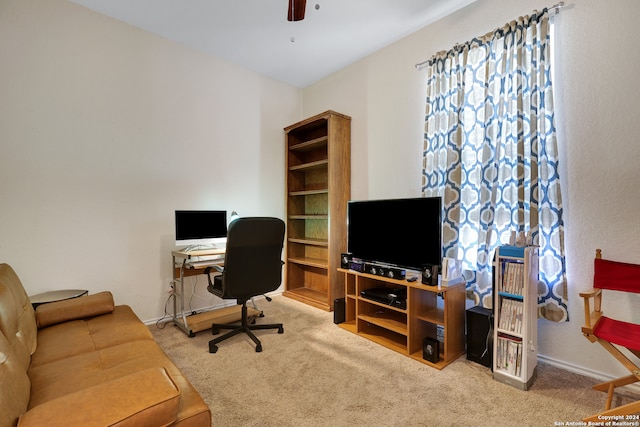 carpeted office space featuring ceiling fan