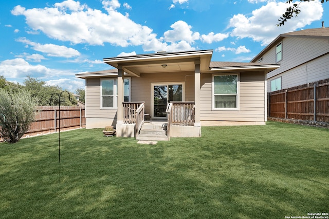 rear view of property with a lawn