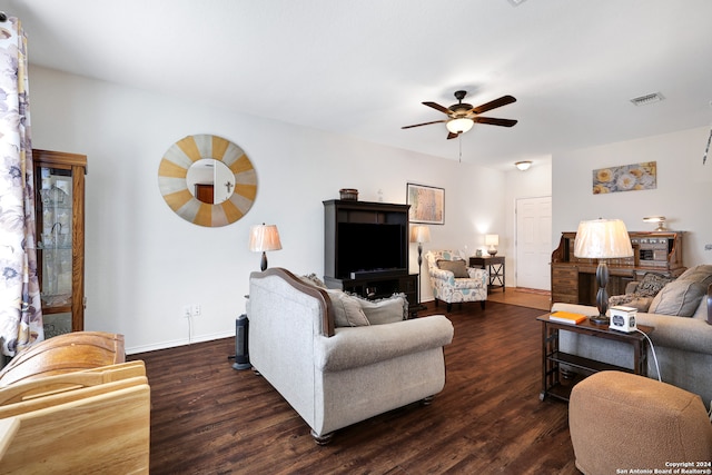 living room with dark wood-type flooring and ceiling fan