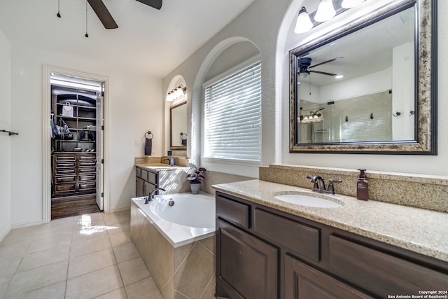 bathroom featuring vanity, independent shower and bath, ceiling fan, and tile patterned flooring