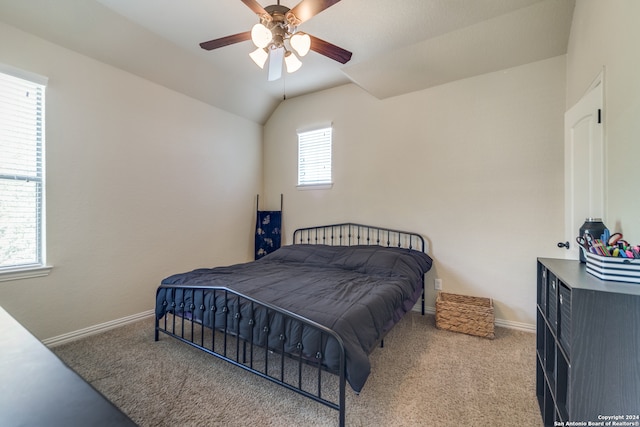 bedroom featuring lofted ceiling, carpet flooring, multiple windows, and ceiling fan