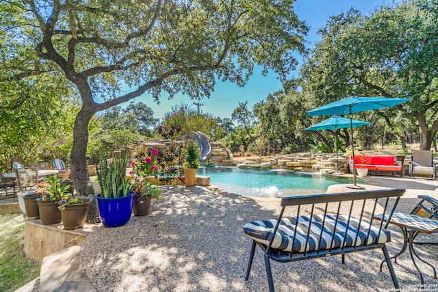 view of pool with a patio and pool water feature