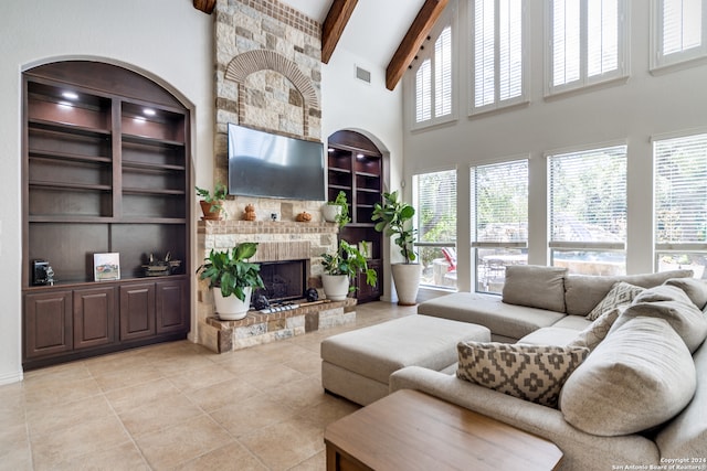 tiled living room featuring beam ceiling, a healthy amount of sunlight, high vaulted ceiling, and built in shelves