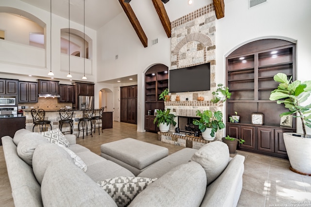 living room featuring high vaulted ceiling, beamed ceiling, light tile patterned flooring, and a fireplace