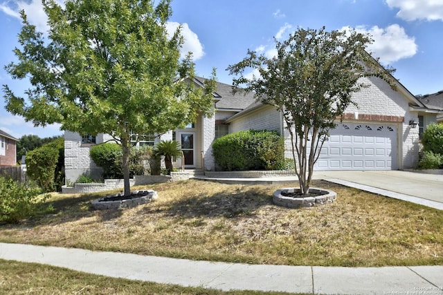 view of property hidden behind natural elements with a garage