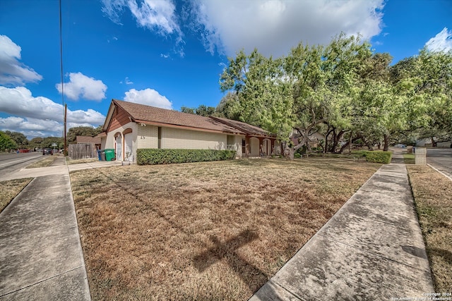 view of side of home featuring a lawn