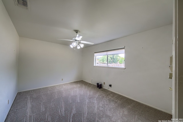 carpeted spare room with ceiling fan