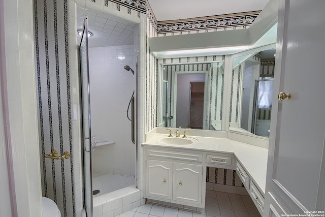 bathroom featuring vanity, tile patterned flooring, toilet, and walk in shower