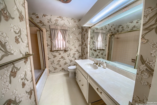 bathroom with vanity, toilet, and an enclosed shower