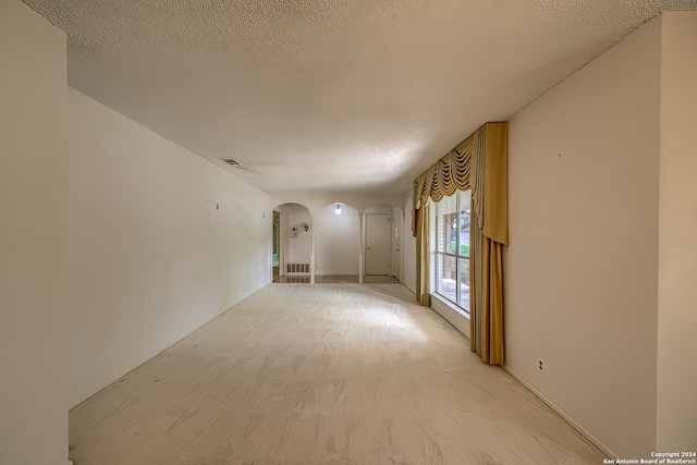 empty room featuring a textured ceiling