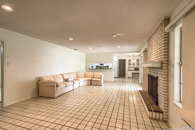 unfurnished living room featuring a textured ceiling, light tile patterned floors, and a fireplace